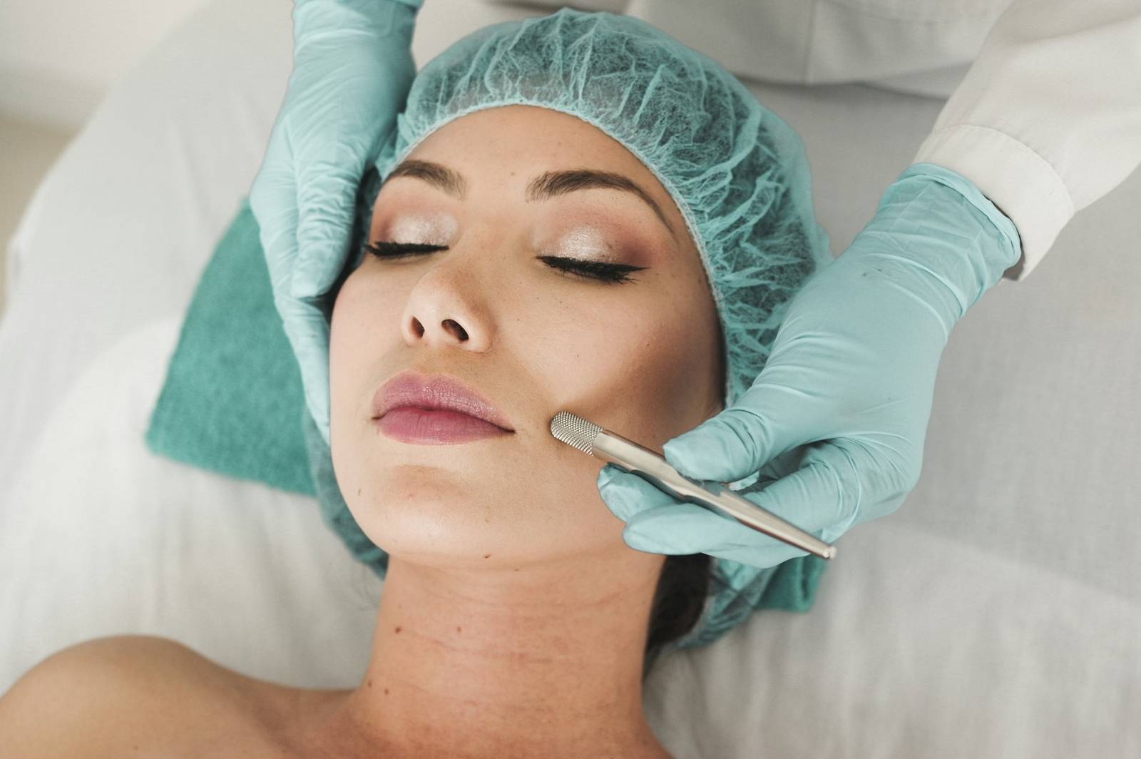 A practitioner carrying out a skin treatment on a client